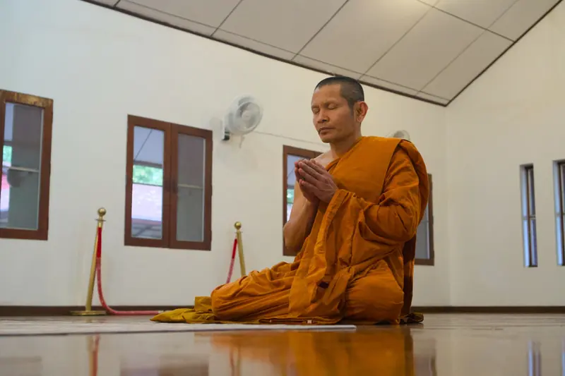 Buddhist monk meditating inside a Chiang Mai temple